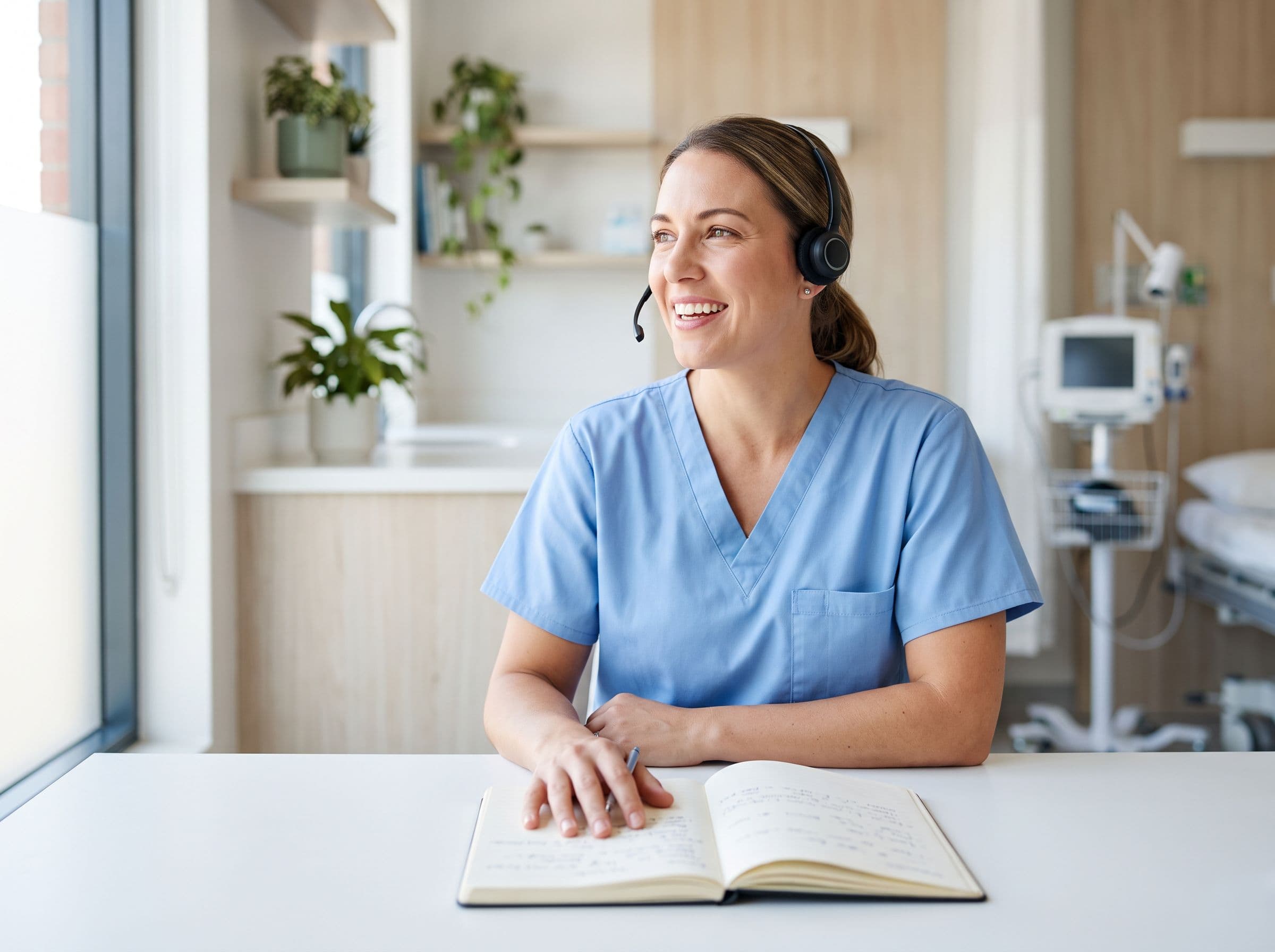 A nurse on a patient call with an open chart at a clinic desk